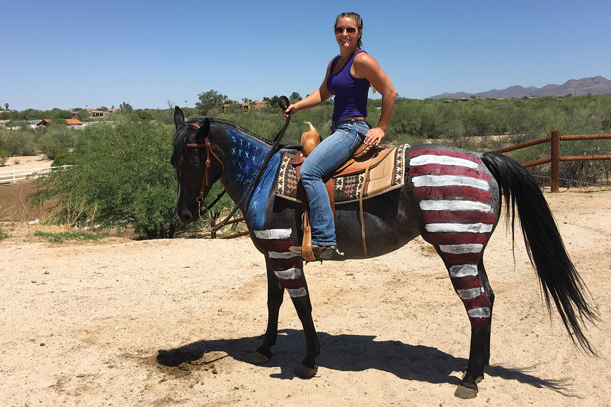 Leah McKeever riding Rosie, who dons an American flag painted onto her body