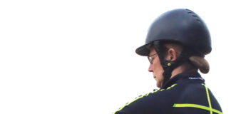 An equestrian assesses her breathing before mounting