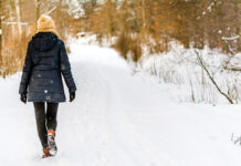 A woman walking in the snow.