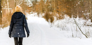 A woman walking in the snow.