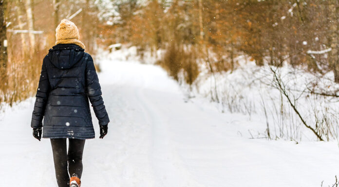 A woman walking in the snow.