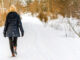 A woman walking in the snow.