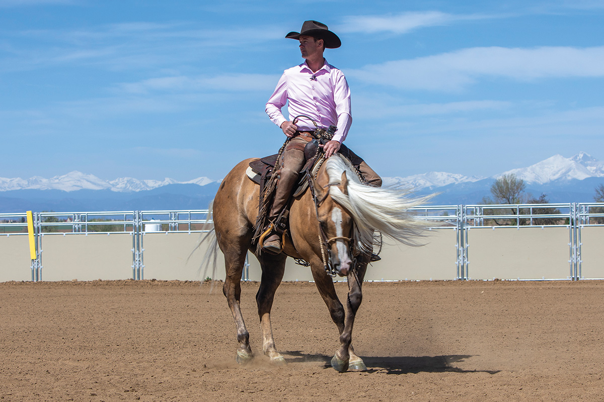 Cody Crow turning a palomino horse