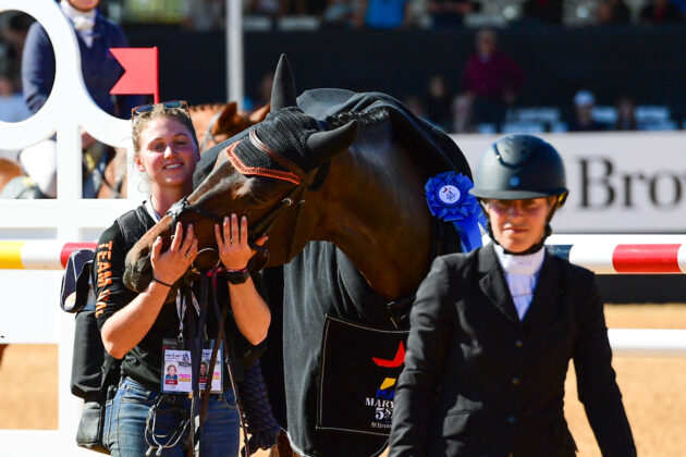 Jaguars Duende, ridden to first place in the 3* by Sharon White, gives a grateful thank-you nudge to groom Kate Servais during the awards ceremony at the 2024 Maryland 5 Star at Maryland