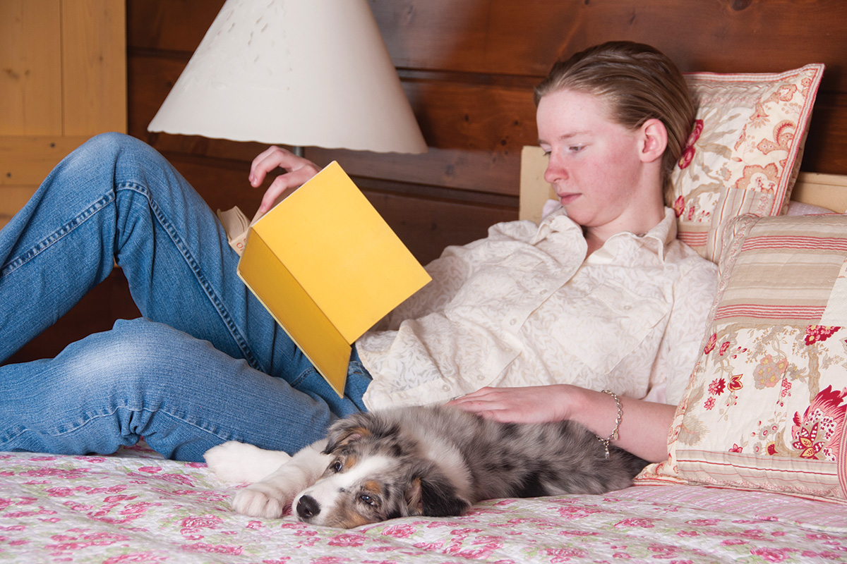 An equestrian reads a book, one of many helpful winter activities when there's less time for riding.