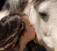 woman kissing horse