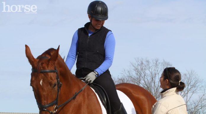 Riding instructor talking to a student on horseback