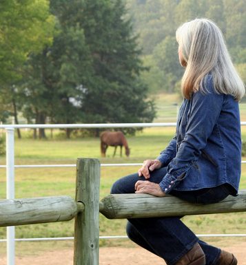 woman horse fence