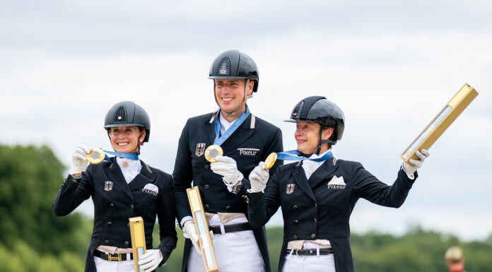 Germany's dressage team on the podium with their gold medals