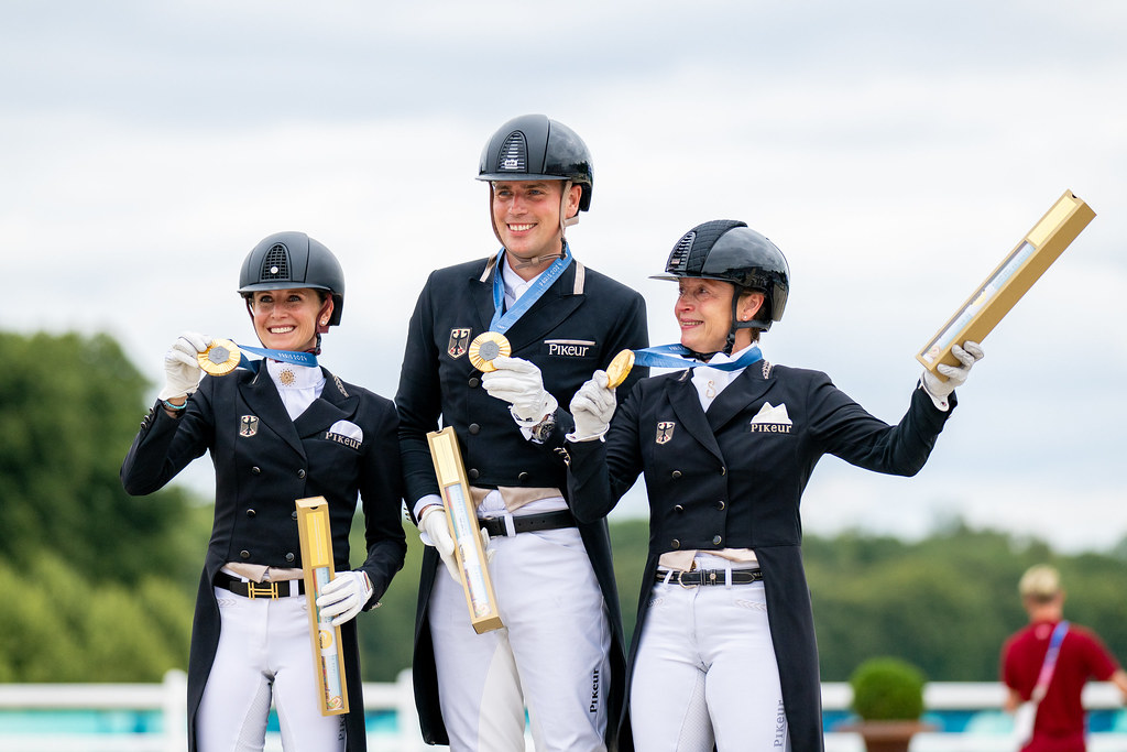 Germany's dressage team on the podium with their gold medals