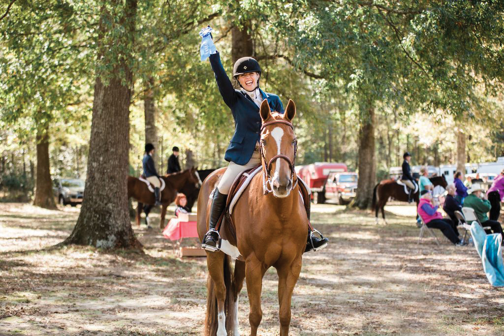 Amanda celebrates her and Athenian Lady's first ribbon at a horse show