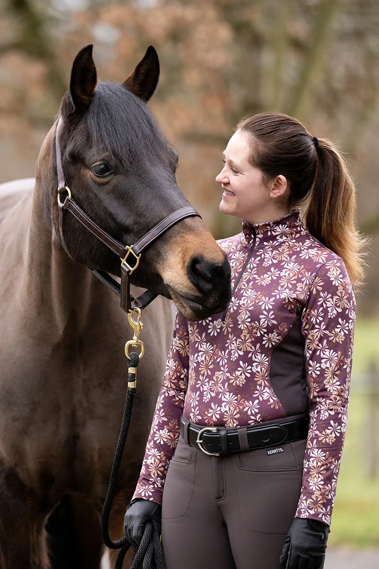 An equestrian wearing the Kerrits printed top, one of the picks on this fall gear list