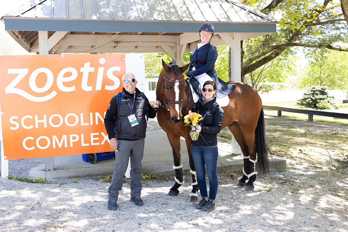 Colleen Rutledge and Cover Rights in front of a Zoetis sign