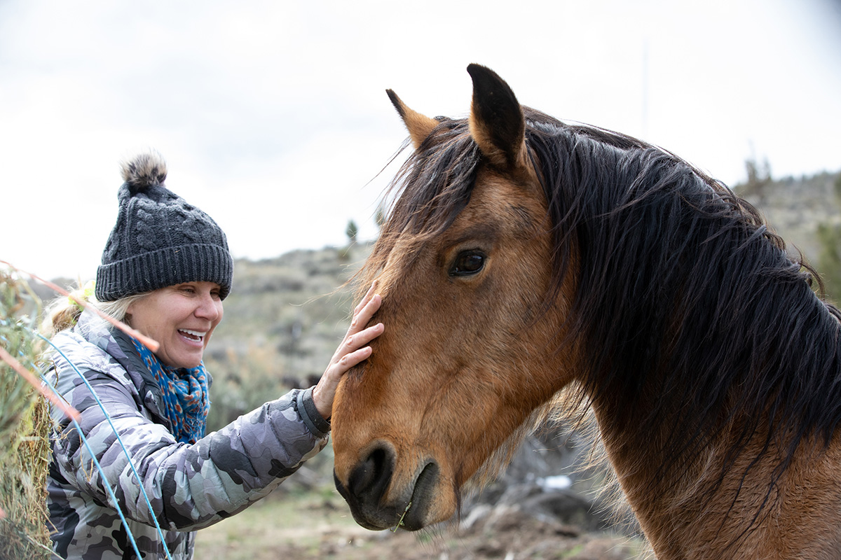 Clare Staples with a mustang