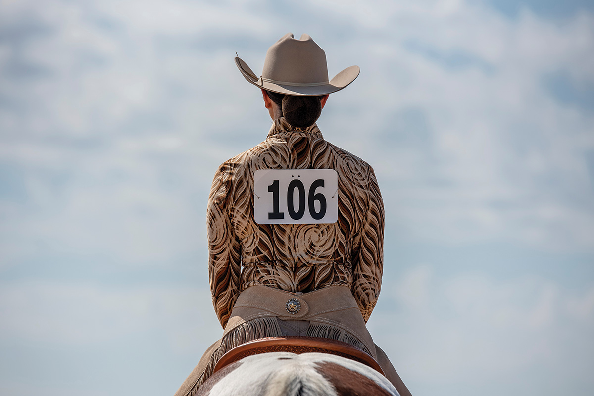 The rear view of a western rider.