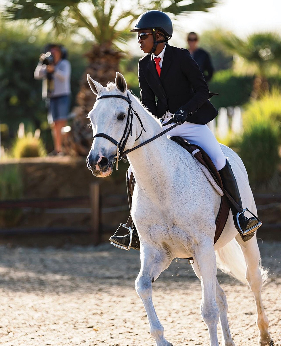 A young boy riding a horse