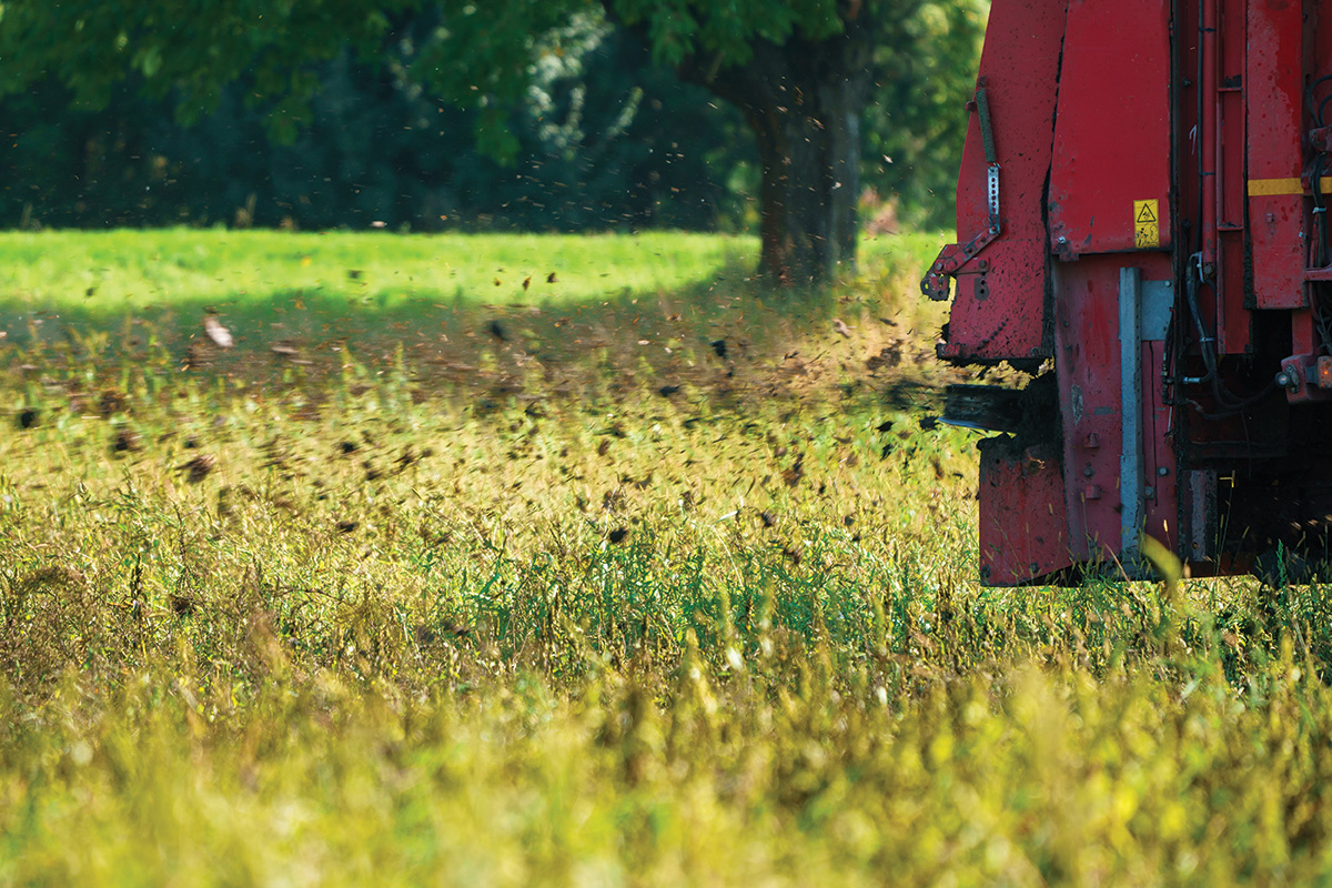 A machine adding a thin layer of organic matter to a field