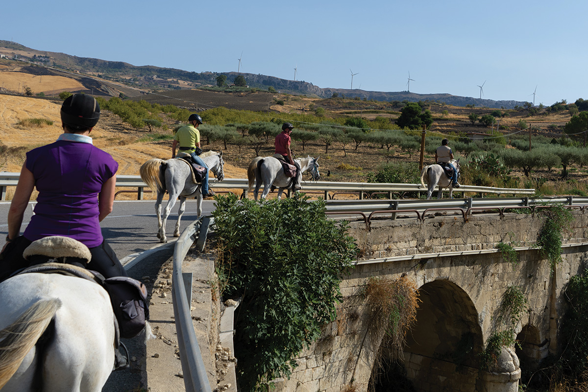 Horseback riding over a bridge in Sicily, Italy