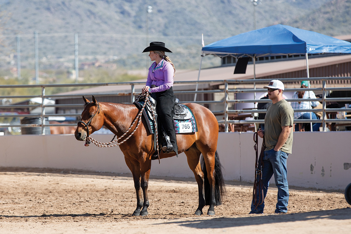 An equestrian takes a moment to have quiet time to calm her horse show nerves and anxiety