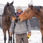 Colorado-based dressage trainer Nahshon Cook with two horses in the snow. Cook is a proponent of trauma-informed horsemanship.