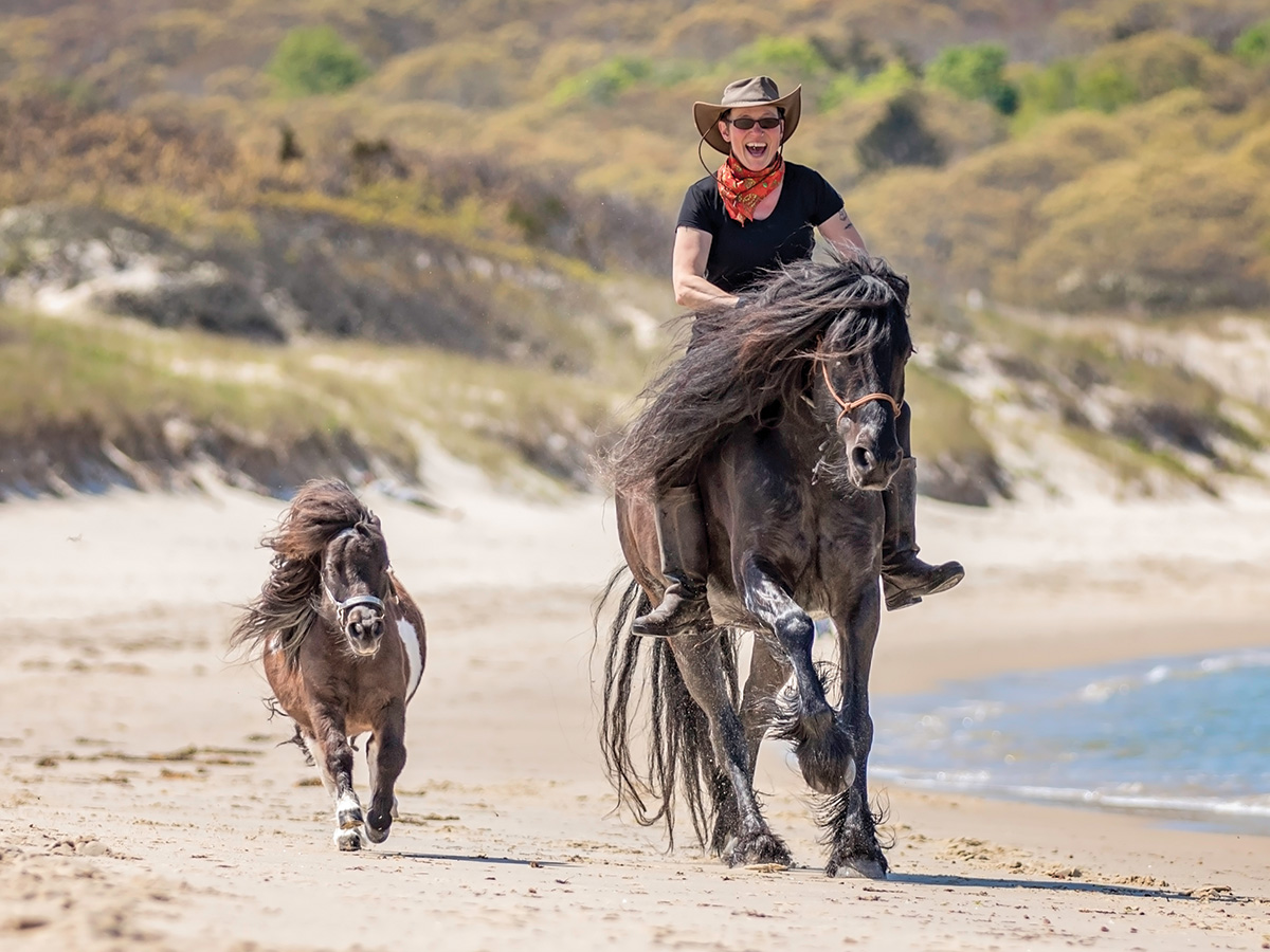 Tony Smalls galloping on the beach with Annie and her Dales Pony, Bucky