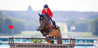 Laura Kraut (USA) and Baloutinue clear the Eiffel Tower jump with the backdrop of Palace of Versailles — a summary of the Paris 2024 Olympic equestrian setting