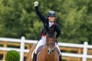 Laura Collett celebrates aboard London 52 after setting an Olympic record with a score of 17.5 in eventing dressage