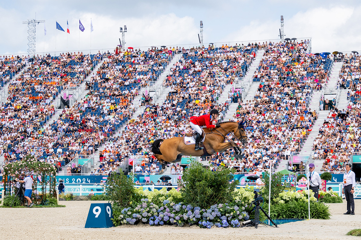 McLain Ward (USA) and Ilex sail over a jump before a large crowd