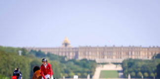 Boyd Martin and Fedarman B jumping with the Palace of Versailles in the background