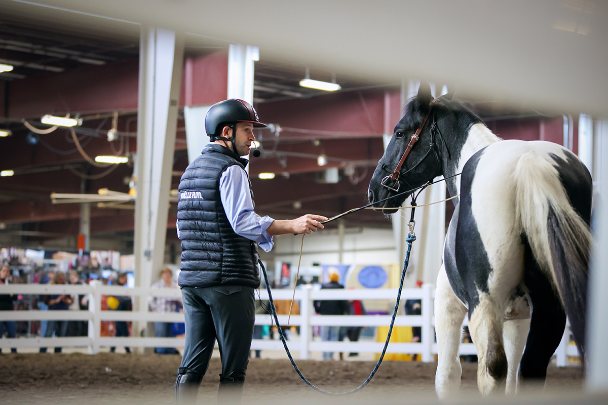 Tik Maynard works with a young horse at Equine Affaire 2024.