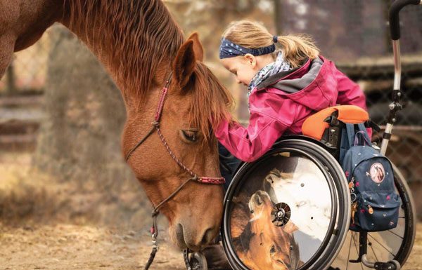 mustang and little girl in wheelchair